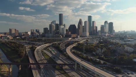 Aerial-view-of-cars-on-freeway-with-downtown-Houston-in-the-background