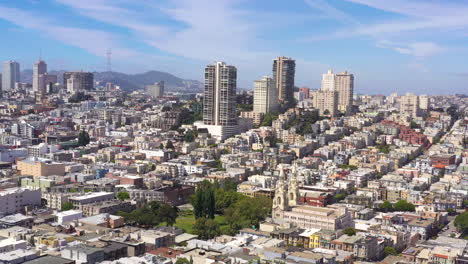 Aerial-view-of-buildings-in-San-Francisco-California-near-downtown,-also-showing-Saints-Peter-and-Paul-Church,-drone-ascending,-day-time
