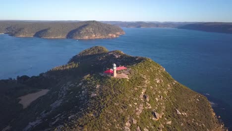 Ascending-drone-video-footage-of-Barrenjoey-Lighthouse-with-ocean-view,-Palm-Beach,-Australia