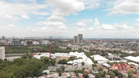 Aerial-panoramic-view-of-southern-Mexico-City,-CDMX,-drone-is-flying-backwards-with-views-to-the-north-of-the-city