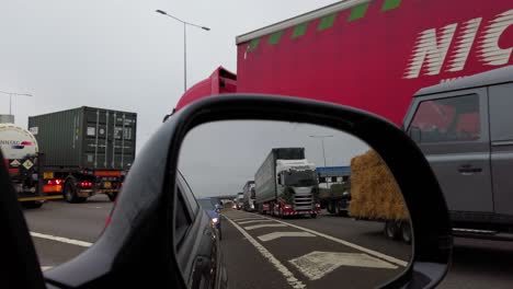 Side-mirror-view-of-slow-moving-traffic-on-M1-motorway