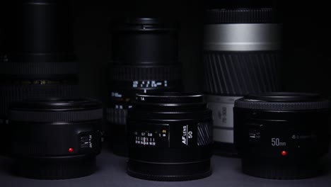 The-light-moves-over-the-camera-lenses-on-a-black-dark-background