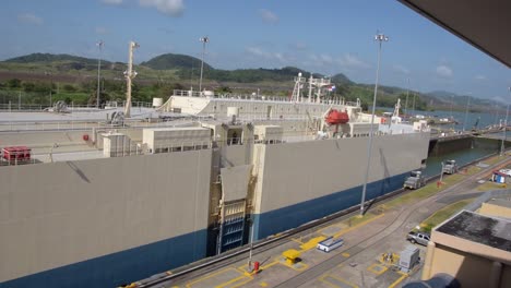 A-huge-cargo-ship-transporting-cars-just-crossing-one-of-the-gates-at-the-Panama-Canal-1