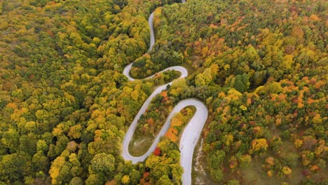 Aerial-drone-footage-of-twisty-mountain-road-in-autumn---12