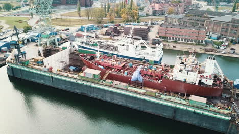 Drone-flying-around-cargo-ship-in-the-shipyard-docks