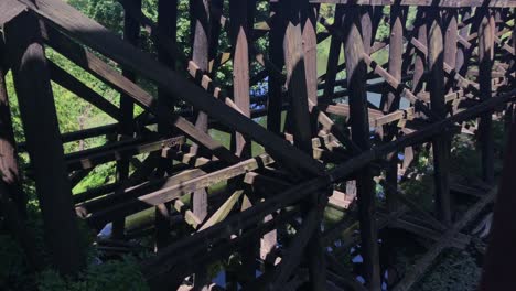 Handheld-footage-of-old-wood-supports-to-a-railroad-bridge-over-a-river-in-Oregon