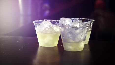 Bartender-pours-last-bit-of-maragarita-mix-into-salt-lined-plastic-cups