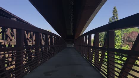 Handheld-footage-of-a-rusted-steel-bridge-over-a-river