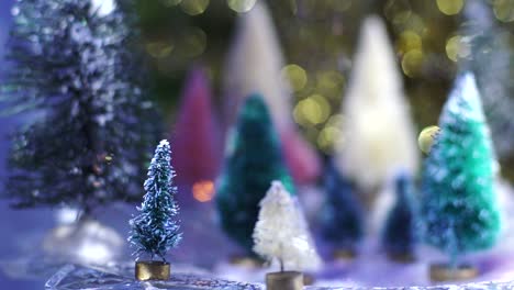 Slow-Motion-snow-glitter-falls-on-bottlebrush-tree-forest-with-gold-and-blue-bokeh-background-at-night