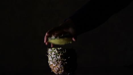 Male-Disassemble-Pineapple,-Ananas-in-The-Dark