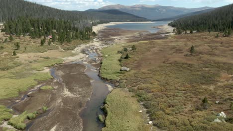 Aerial-dolly-over-small-river-into-reservoir-in-Colorado