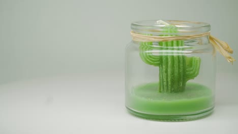 A-lovely-display-of-a-handcrafted-green-vegetable-like-a-cactus-kept-in-a-glass-jar-in-a-turntable-for-home-display---close-up