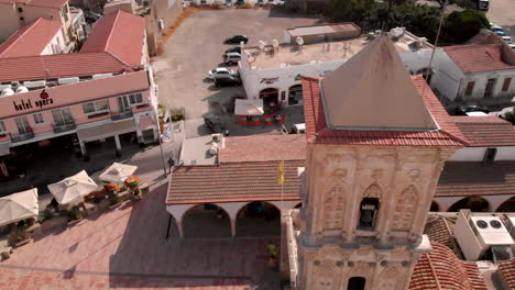 Old-church-of-Saint-Lazarus-in-Greece-during-daytime,-descending-aerial-tilting-up