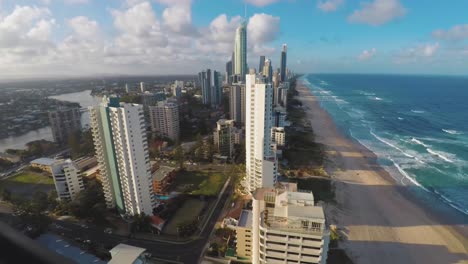 A-timelapse-of-Surfers-Paradise,-Goldcoast-Queensland,-Australia-show-from-a-unique-angle-that-shows-both-the-beach-and-the-city-as-the-day-goes-by