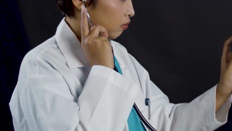 Tight-framing-of-a-female-doctor-or-nurse-examining-a-patient-with-a-stethoscope