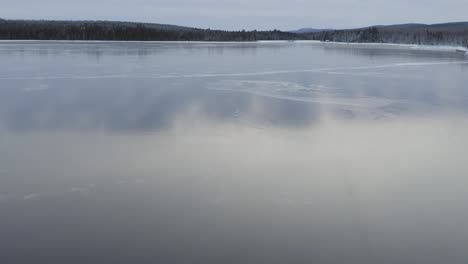 Reflective-ice-across-frozen-lake-surface-Aerial