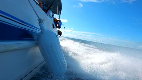 A-slow-motion-shot-right-above-the-water-as-a-speed-boat-splashed-through-the-ocean
