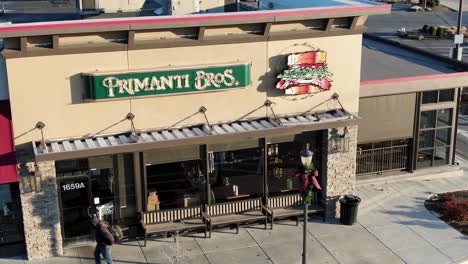 Aerial-of-Primanti-Bros-Brothers-restaurant-with-customer-walking-by