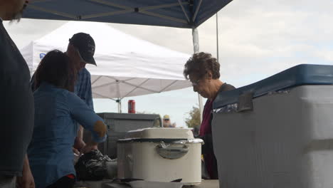 An-old-woman-getting-a-plate-of-BBQ-at-a-local-fundraiser