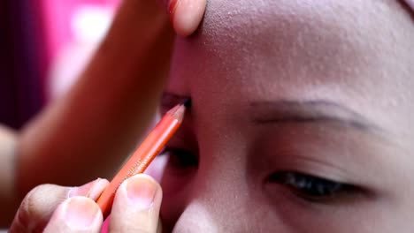 Make-up-artist-work-on-her-client,-beautiful-teen-girl,-Pekalongan-Indonesia