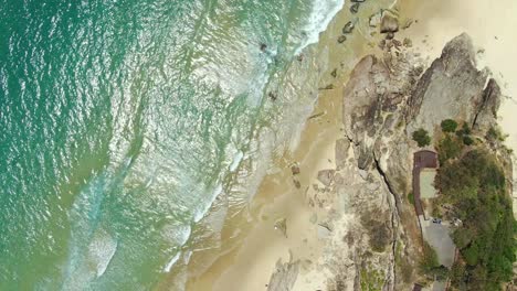 Rocky-Headland-,crystal-clear-water,-small-waves,-from-the-vertical-,-Drone-shot-holding-still-for-wonderful-footage