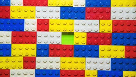 Stop-motion-transition-with-legos,-top-view,-with-green-screen-in-the-background