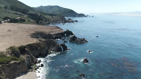 Down-tilt-of-rocky-shore-of-the-Pacific-Ocean-near-notleys-landing-viewpoint-close-to-Highway-1-in-California,USA