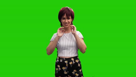 Cheerful-short-haired-brunette-female-adjusting-hair-on-green-screen