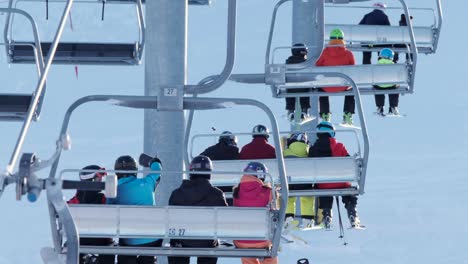 Skiers-and-snowboarders-ride-4-person-chairlift-to-top-of-COP-Calgary