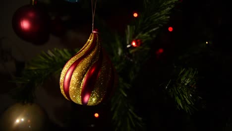 Golden-Ornament-Hanging-on-Christmas-Tree-Branch,-Close-Up