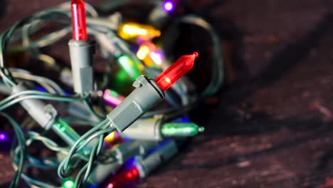 4k-close-up-of-colorful-Christmas-tree-lights-on-table-top-blinking