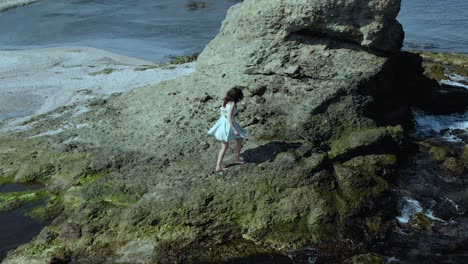 Aerial-slow-motion-shot-of-pretty-girl-in-white-dress-walk-on-the-beach-3