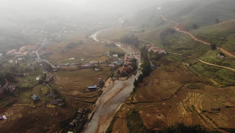 Cinematic-aerial-drone-footage-of-rice-terraces-and-farm-work-in-north-region-of-Sapa-Vietnam-with-sun-shining-through-clouds-after-long-day-of-rainfall