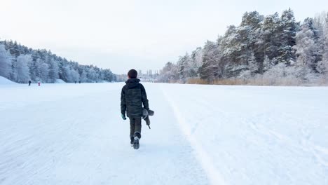 Boy-walking-on-frozen-lake