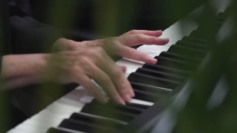 Close-up-of-Middle-Aged-hands-playing-piano-in-slow-motion