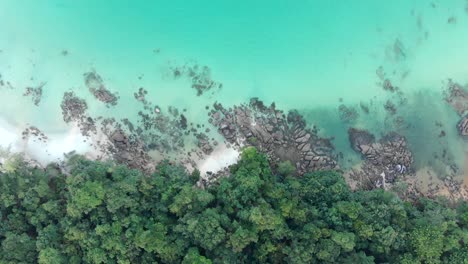 Birds-eye-view-of-tropical-island-paradise-coastline-with-clear-blue-water-and-rocky-forest-cambodia
