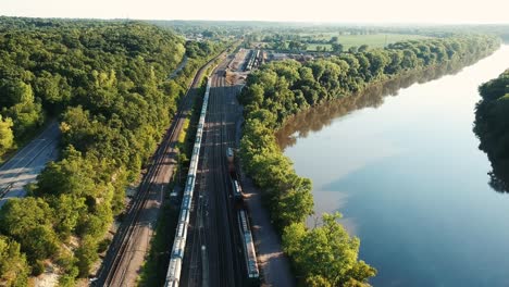Drone-video-lowering-down-towards-train-tracks-with-river-next-to-it