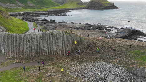 Aerial-dolly-of-tourists-visiting-the-Giant's-Causeway-in-Northern-Ireland