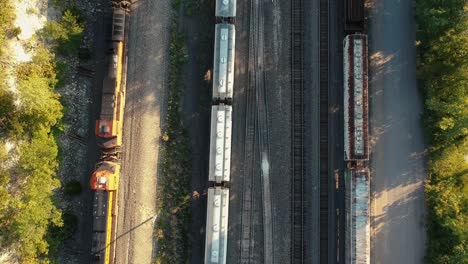 Top-down-drone-video-of-train-coming-down-the-tracks
