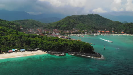Wide-aerial-view-of-the-Bias-Tugel-Beach-and-Padang-Bai-Port-on-a-warm-cloudy-day-in-Bali