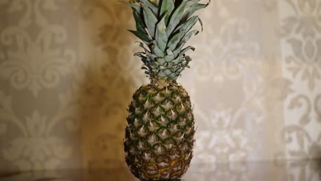Rotating-Sweet-Pineapple-Ananas-On-The-Table