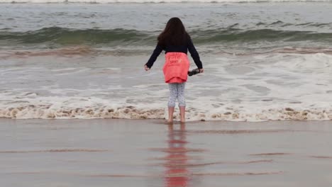 Young-girl-with-dark-hair-enjoying-Irish-sea-tide-on-the-coast-1