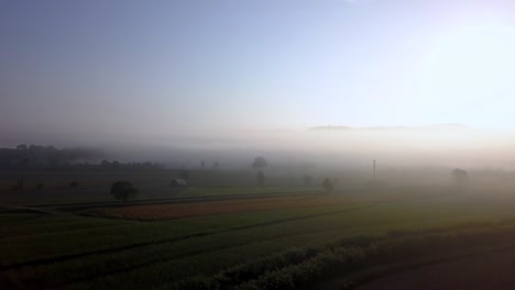 Tuscany-Italy-countryside-in-the-morning-with-heavy-fog,-Aerial-drone-pan-right-reveal-shot