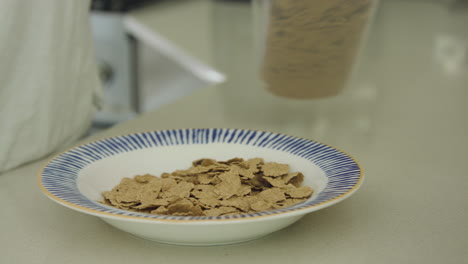 Close-up-tracking-shot-of-generic-cereal-being-poured-into-a-bowl