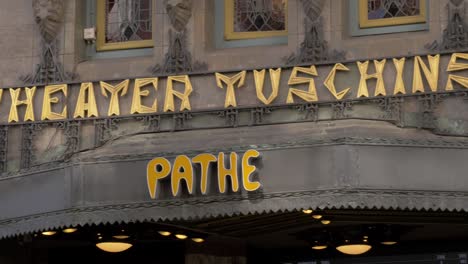 Entrance-of-Tuschinski-Film-Theatre-In-Amsterdam,-Netherlands---Pannig-left-to-right