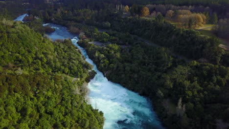 Aerial-Drone-shot-of-Blue-river-and-White-Rapids-next-to-a-green-forest-in-New-Zealand