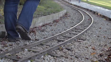 Person-walking-alongside-monorail-train-track
