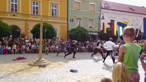 Slow-motion-of-medieval-sword-battle-between-commoners-and-knights-in-the-main-square,-Preludij-festival-in-Slovenj-Gradec-slovenia