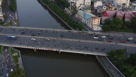 High-angle-panning-aerial-view-of-Dien-Bien-Phu-Bridge,-Binh-Thanh-district,-Ho-Chi-Minh-City,-Vietnam-which-crosses-the-Hoang-Sa-canal