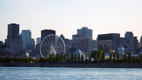 Montreal,-river-view,-background-scene,-downtown,-skyscrapers,-buildings,-pyramid-Py,-ferris-wheel,-old-port-of-Montreal-cityscape,-blue-sky,-city,-urban,-smooth-zoom-in